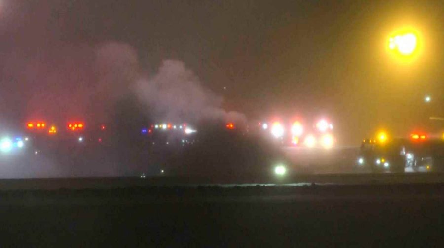 This image taken from video provided by WABI television, emergency services work on a scene of the Bombardier Challenger 600 crash at the Bangor Airport in Maine, late Sunday, Jan. 25, 2026. (WABI via AP)