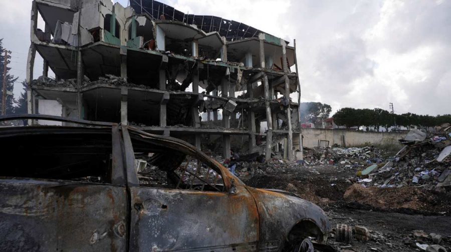 A damaged car near a damaged building in the aftermath of an Israeli strike on a healthcare center, where, according to a Lebanese state news agency report citing the country's Health Ministry, multiple members of medical personnel were killed, following an escalation between Hezbollah and Israel amid the U.S.-Israeli conflict with Iran, in Borj Qalaouiya, southern Lebanon, March 15, 2026. REUTERS/Mohammad Yassine