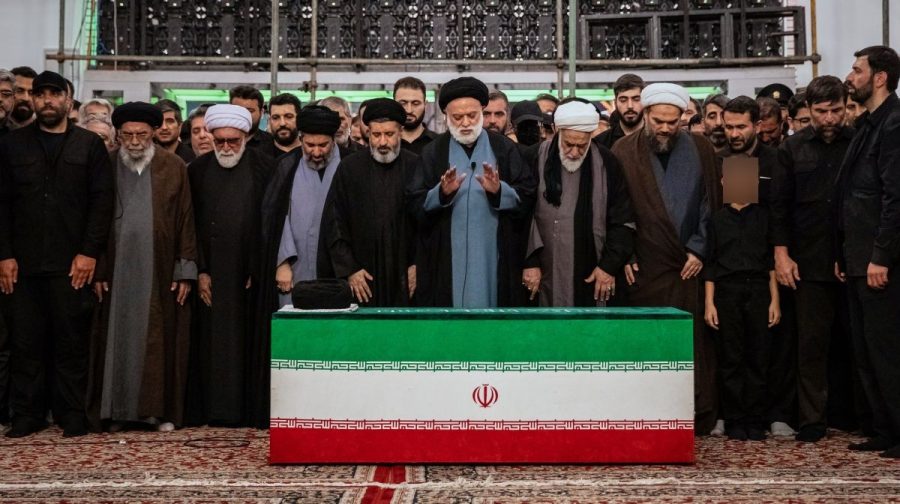 Mostafa Khamenei, center, brother of Iran's new Supreme Leader Mojtaba Khamenei, leads a prayer over the coffin of his late father, Iranian Supreme Leader Ayatollah Ali Khamenei before his burial at the Imam Reza Shrine in Mashhad, northeastern Iran, Thursday, July 9, 2026.