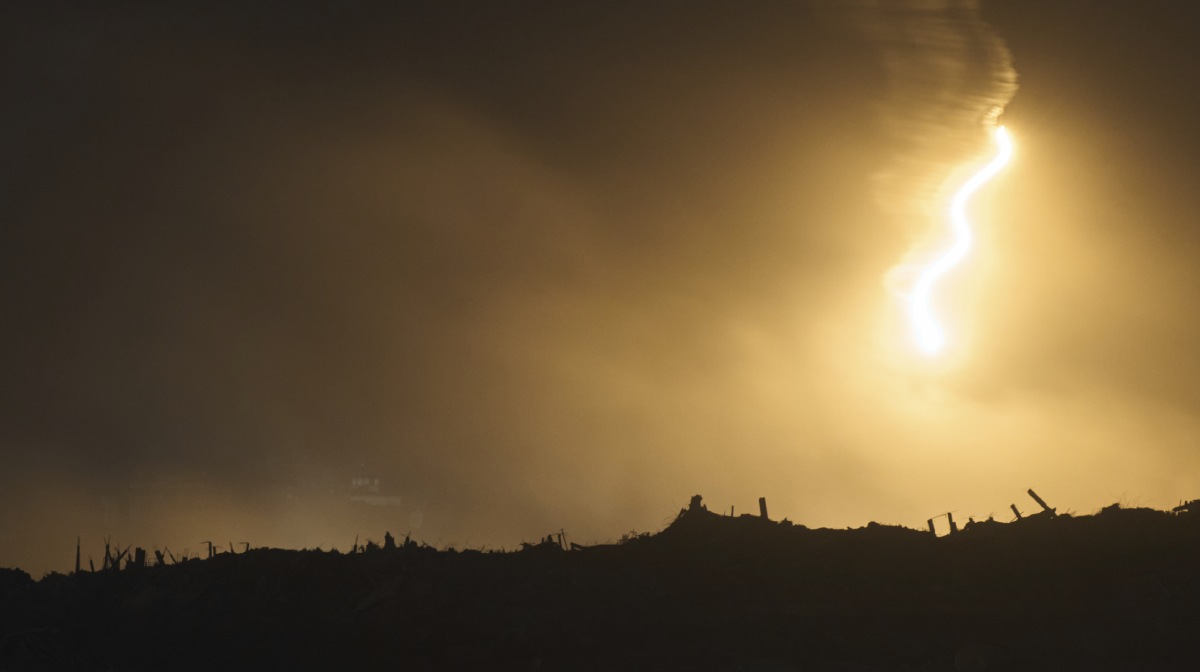 An Israeli army flare drifts over an area in the northern Gaza Strip, as seen from southern Israel, Tuesday, Oct. 28, 2025. (AP Photo/Leo Correa)