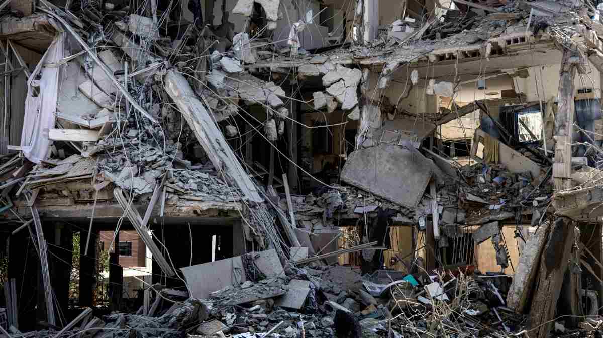 A destroyed building is pictured at a site in Tel Aviv hit by a missile fired from Iran on June 14, 2025. Israel's military said that its fighter jets were set to resume striking targets in Tehran, after announcing it had hit air defences in the Iranian capital area overnight, as Israel and Iran trade fire with such intensity for the first time following decades of enmity and conflict by proxy, with fears of a prolonged conflict engulfing the region. (Photo by JOHN WESSELS / AFP)
