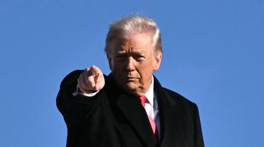 US President Donald Trump gestures as he boards Air Force One at Joint Base Andrews, Maryland on January 13, 2026, as he travels to Detroit, Michigan. (Photo by Mandel NGAN / AFP)