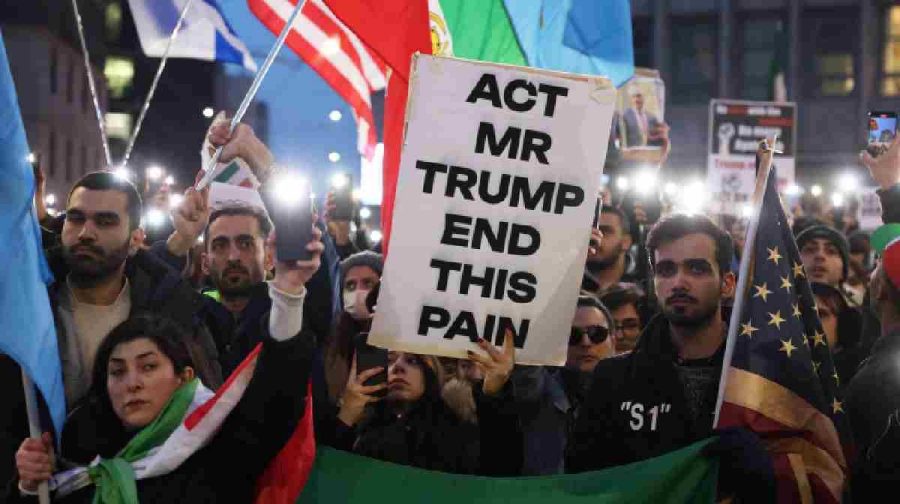 People light up their phones outside the U.S. consulate during a rally in support of nationwide protests in Iran, in Milan, Italy, January 13, 2026. REUTERS/Claudia Greco
