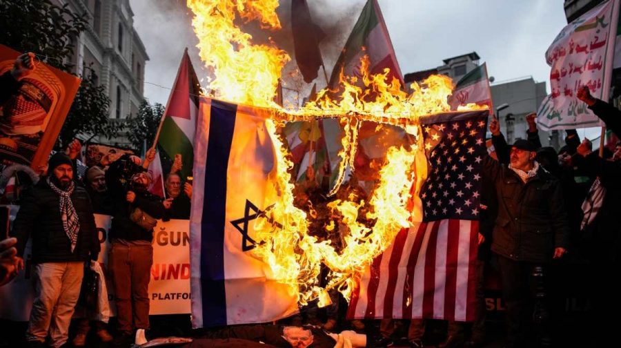 People burn U.S. and Israel flags during a rally in support of the Iranian government, in Istanbul, Turkey, Sunday..(AP Photo/Emrah Gurel)
