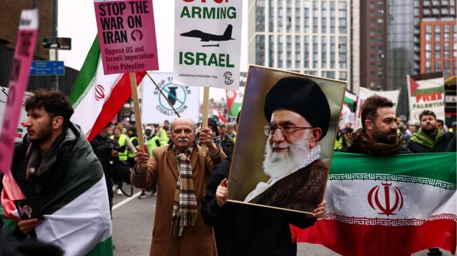 An anti-war activist holds an image of Iran's late Supreme Leader Ayatollah Ali Khamenei as others hold signs and Iranian flags during a march organised by Stop the War Coalition, calling for an end to hostilities amid the U.S.-Israeli conflict with Iran, in London, Britain, March 7, 2026. REUTERS/Jack Taylor