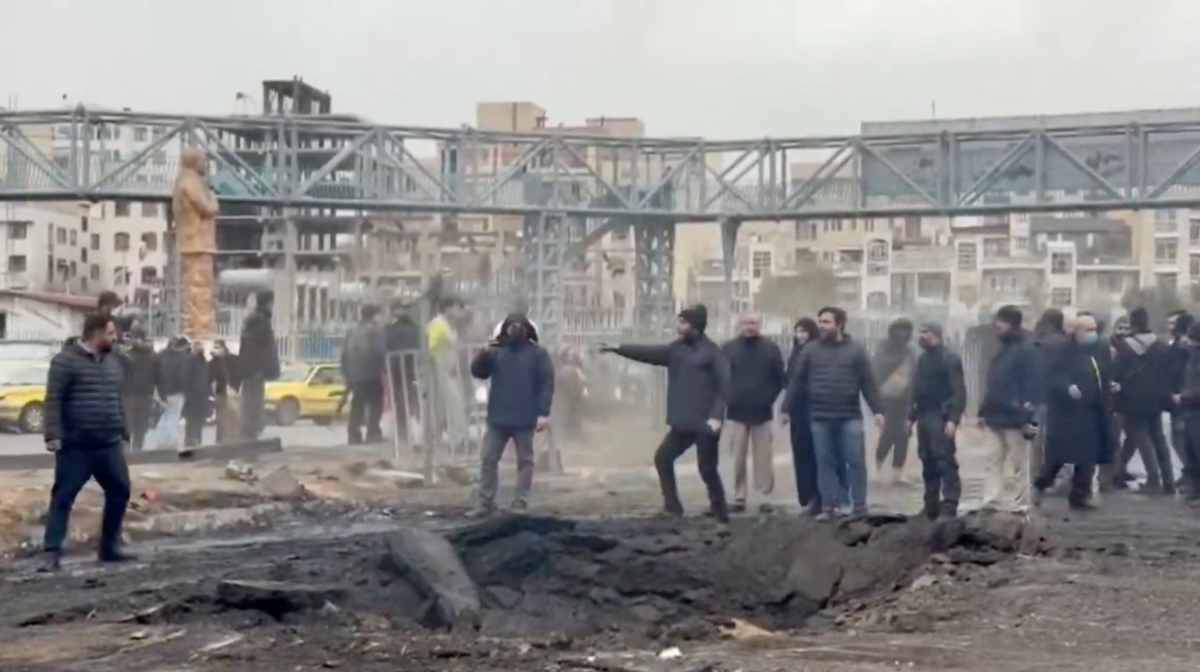 People stand at an affected area on the street, following a reported strike, amid the U.S.-Israeli conflict with Iran, in Tehran, Iran, in this screengrab from a a handout video released March 10, 2026. Iranian Red Crescent Society/Handout via REUTERS THIS IMAGE HAS BEEN SUPPLIED BY A THIRD PARTY. NO RESALES. NO ARCHIVES. MANDATORY CREDIT. VERIFICATION: Reuters confirmed the location as Tehran, Iran, by the buildings, bridges and roads seen in the video, which matched satellite and file imagery of the area. The exact date when it was filmed could not be verified, but no older version was found posted online before March 10. Iranian government reported about a strike in the area on March 10.