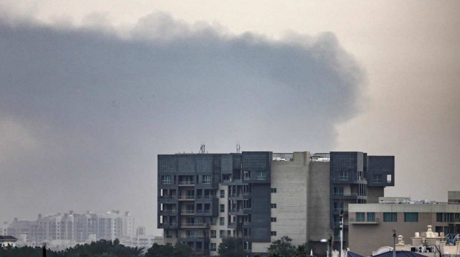 Smoke rises above Dubai on March 13, 2026. Explosions rattled buildings in Dubai and a large cloud of smoke hung over a central area of the Middle East financial hub on March 13, AFP correspondents said. (Photo by AFP) / 