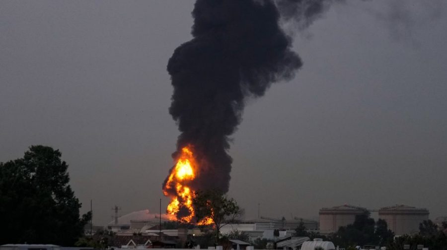 Fire and plumes of smoke rises after a drone struck a fuel tank forcing the temporary suspension of flights. near Dubai International Airport, in United Arab Emirates, early Monday, March 16, 2026. (AP Photo)