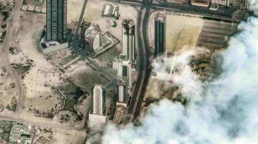 TOPSHOT - This handout satellite image courtesy of Vantor shows damage following a drone attack on a high-rise apartment building in Bahrain's capital Manama on March 2, 2026. The Gulf countries have long been seen as islands of stability in the Middle East, but the war in the region could threaten their prosperity, analysts said, pointing to risks to their revenues and reputations as business safe havens. (Photo by Satellite image ©2026 Vantor / AFP) / RESTRICTED TO EDITORIAL USE - MANDATORY CREDIT "AFP PHOTO / SATELLITE IMAGE (C) 2026 Vantor" - HANDOUT - NO MARKETING NO ADVERTISING CAMPAIGNS - DISTRIBUTED AS A SERVICE TO CLIENTS - THE WATERMARK MAY NOT BE REMOVED/CROPPED