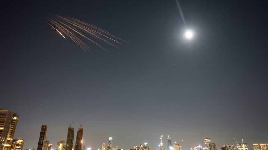 Missiles launched from Iran are seen in the sky over central Israel, Thursday, March 5, 2026. (AP Photo/Ohad Zwigenberg)