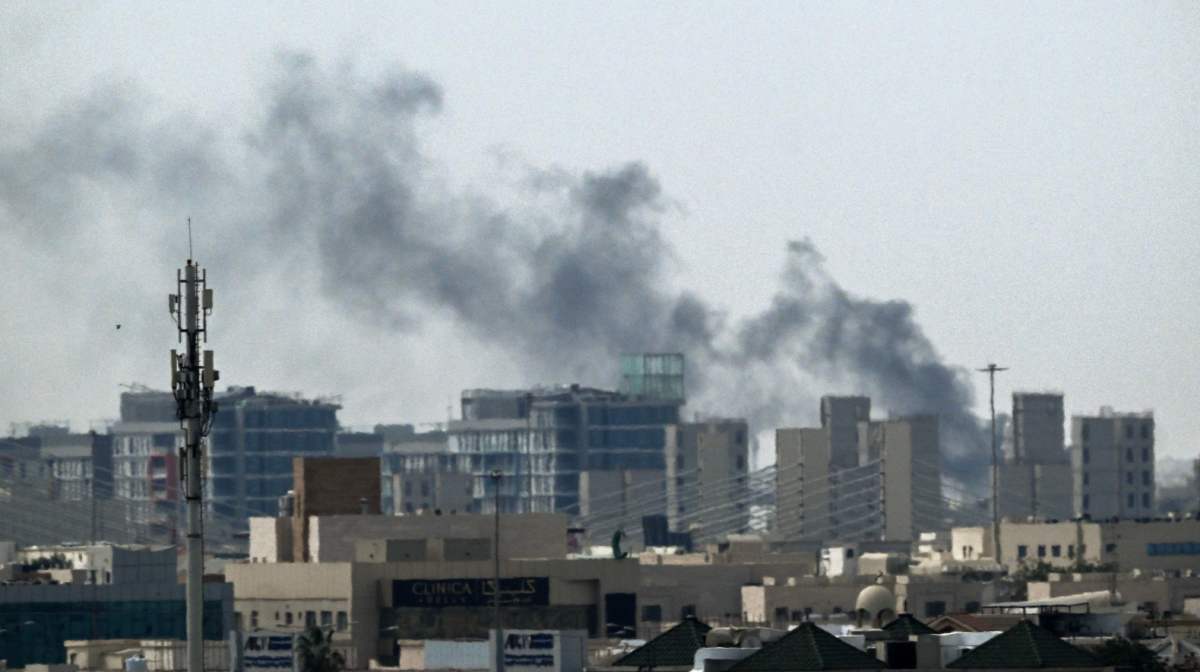 A plume of smoke rises over buildings in Doha on March 5, 2026. Multiple rounds of explosions echoed over Doha on March 5 just hours after officials said they were evacuating residents living near the US embassy. Gulf countries have been targeted by repeated waves of Iranian drone and missile attacks in retaliation for the massive US-Israeli air campaign. (Photo by Mahmud Hams / AFP)