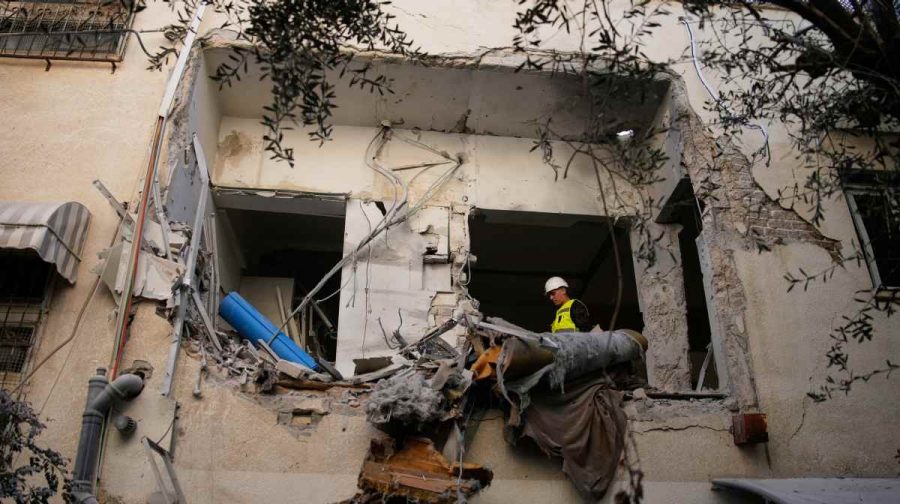 Israeli security forces inspect a damaged apartment building struck by an Iranian missile in Tel Aviv, Israel, Sunday, March 8, 2026. (AP Photo/Ohad Zwigenberg)