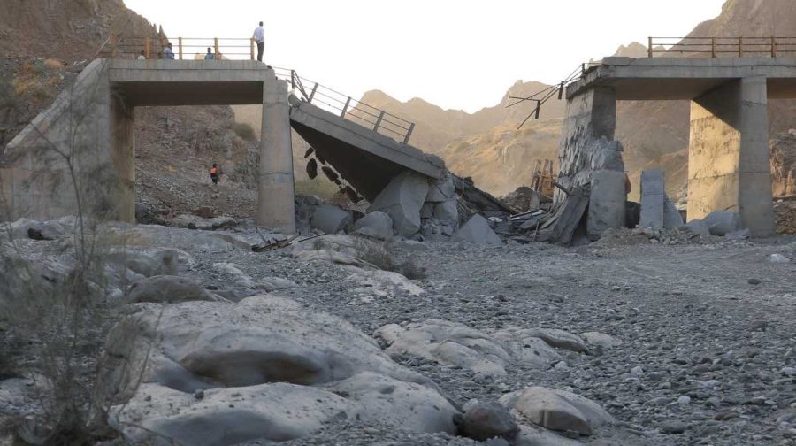 People stand on a bridge destroyed after a strike in Hormozgan province, southern Iran, Saturday, July 18, 2026. (Amirhosein Khorgooi/Iranian Students' News Agency via AP)