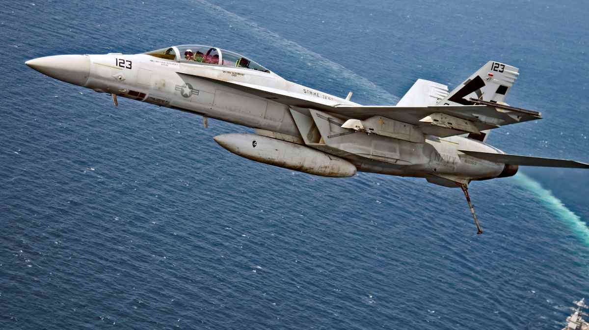 An F/A-18F Super Hornet jet flies over the USS Gerald R. Ford as the U.S. Navy aircraft carrier tests its EMALS magnetic launching system, which replaces the steam catapult, and new AAG arrested landing system in the Atlantic Ocean July 28, 2017. Picture taken July 28, 2017. U.S. Navy/Erik Hildebrandt/Handout via REUTERS ATTENTION EDITORS - THIS IMAGE WAS PROVIDED BY A THIRD PARTYâ ¨