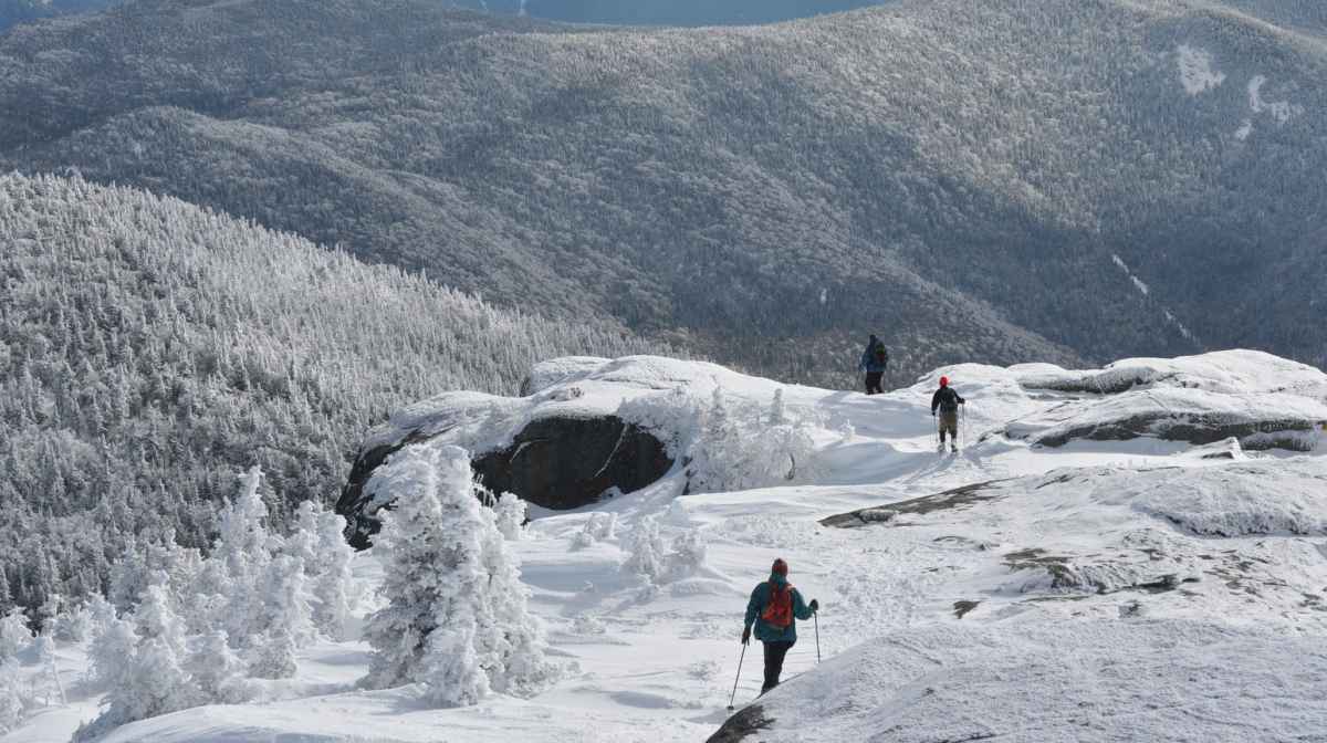 FILE - Three snowshoers descend from the summit of Cascade Mountain in the Adirondacks, March 14, 2011. (Mike Lynch/Adirondack Daily Enterprise via AP,File)