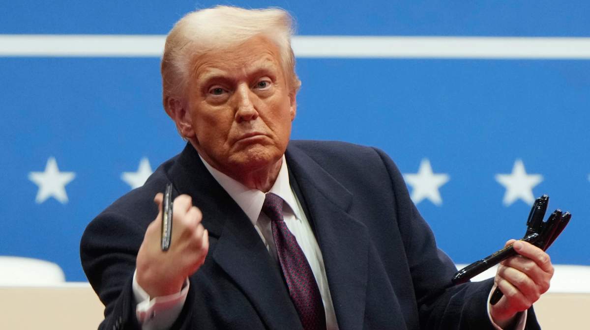 President Donald Trump throws pens used to sign executive orders to the crowd during an indoor Presidential Inauguration parade event in Washington, Monday, Jan. 20, 2025. AP/PTI(AP01_21_2025_000048B)
