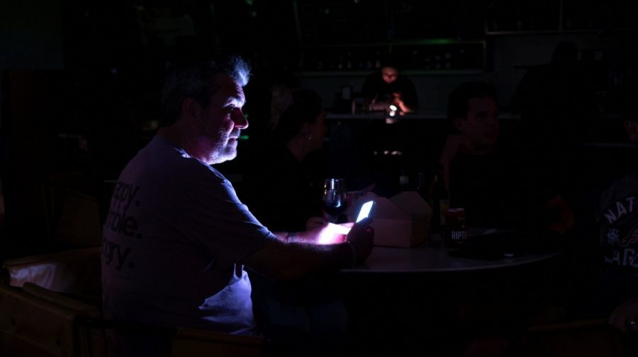 People relax in a hotel lobby during a power outage ahead of the arrival of Hurricane Isaias, in Pensacola, Florida, US, October 9, 2026. REUTERS/Marco Bello