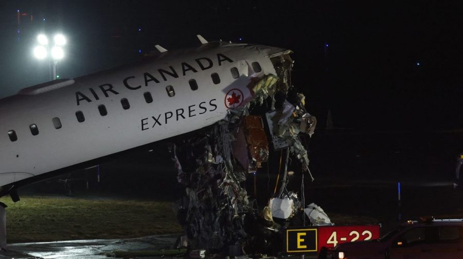 An Air Canada Express CRJ-900 sits on the runway after colliding with a Port Authority fire truck at LaGuardia Airport in New York, on March 23, 2026. Air Canada Express flight AC8646 originated from Montreal and collided with the fire truck during landing. (Photo by ANGELA WEISS / AFP)