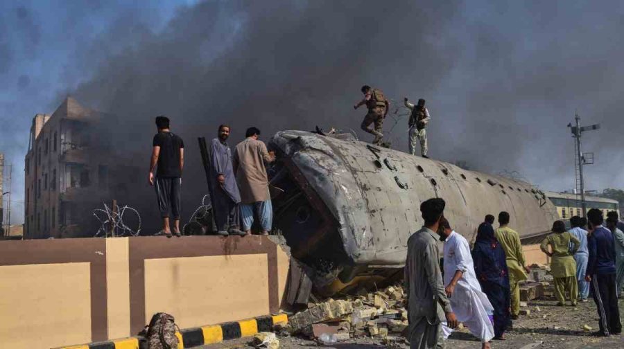 Paramilitary soldiers and volunteers try to recover victims from an overturned train coach on a railway track at the site of a bomb explosion in Quetta, Pakistan, Sunday, May 24, 2026. AP/PTI(AP05_24_2026_000138B)