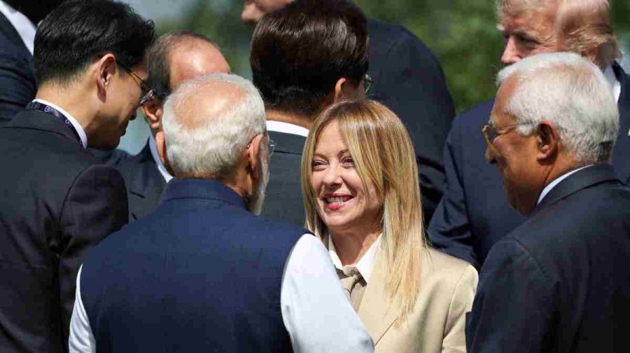 Italy's Prime Minister Giorgia Meloni (C-R) speaks with India's Prime Minister Narendra Modi (C-L) before a family photograph during the G7 summit, in Evian, eastern France, on June 16, 2026. A G7 summit is set to take place June 15 to 17 in the French town of Evian-les-Bains near Switzerland and it will be attended by country leaders as well as the EU's foreign policy chief and ministers from Brazil, Canada, the United Arab Emirates and Turkey. (Photo by Isabel Infantes / POOL / AFP)