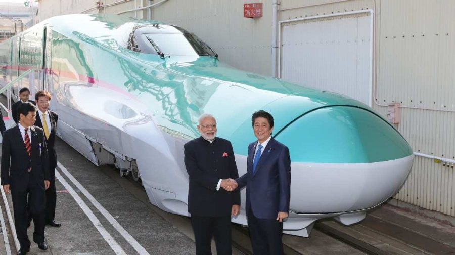 (FILES) This file photo taken on November 12, 2016 shows India's Prime Minister Narendra Modi (2nd R) and his Japanese counterpart Shinzo Abe (R) shaking hands in front of a Shinkansen train during their inspection of a bullet train manufacturing plant in Kobe, Hyogo prefecture.
As India's premier Narendra Modi and his Japanese counterpart Shinzo Abe prepare to break ground on the country's first bullet train project this September 14, 2017, experts say the collaboration could signal a massive leap for its overburdened and deadly railways. / AFP PHOTO / JIJI PRESS / JIJI PRESS / Japan OUT / TO GO WITH AFP STORY INDIA-JAPAN-TRANSPORT-DIPLOMACY,ADVANCER BY JALEES ANDRABI