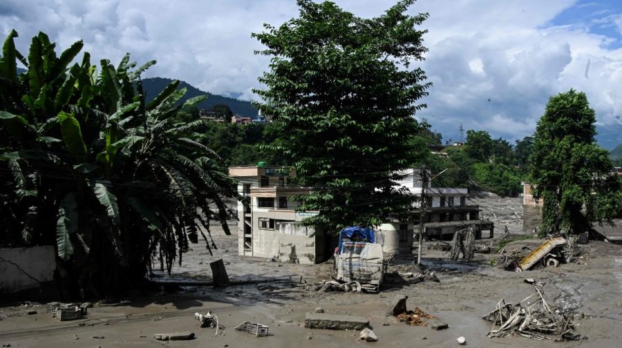 A photograph taken on August 26, 2026 shows a house partially submerged by mud following flash floods and a landslide disaster in Trishuli Bazar, in Nepal's Nuwakot district. A massive flood and landslide disaster on the Nepal-Tibet border killed at least 103 people on August 26, 2026 and left several hundred missing, many of them foreign tourists. Aid workers said entire settlements had been "wiped out". Some 403 tourists -- 341 of them foreigners -- were unaccounted for several hours after the disaster struck, according to the tourism ministry. (Photo by PRAKASH MATHEMA / AFP)