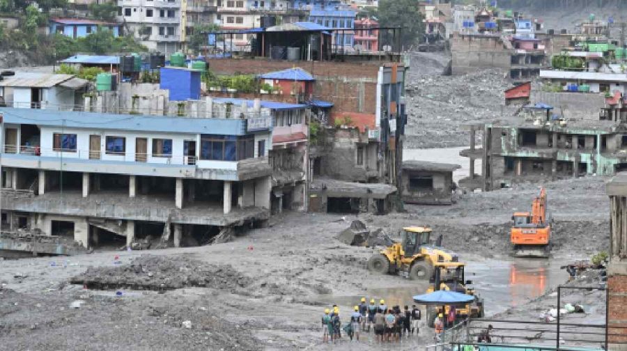 Buildings destroyed by floodwaters in Dhunge, Nuwakot district of Nepal. Rescue operations using excavators are underway in the mud-covered area. @ JOSEKUTTY PANACKAL / MANORAMA