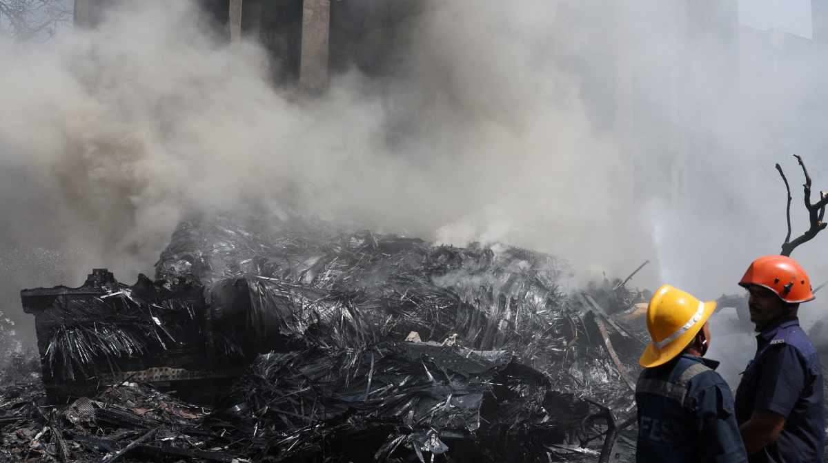Emergency crews work as smoke rises from the wreckage of a Boeing 787 Dreamliner where the Air India plane crashed in Ahmedabad, India, June 12, 2025. REUTERS/Amit Dave     TPX IMAGES OF THE DAY     