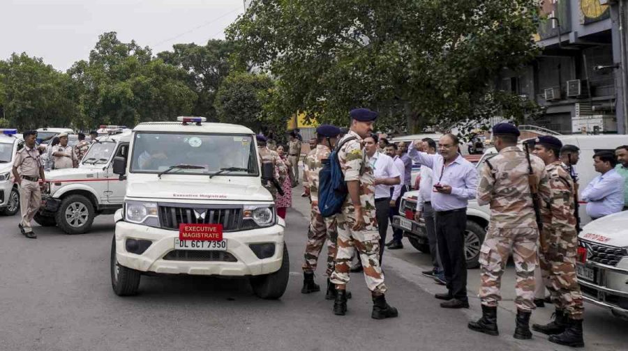 Officials carry examination materials to a NEET-UG examination centre under tight security ahead of the Re-NEET UG 2026 examination, in New Delhi, Sunday, June 21, 2026. The re-examination is being conducted following the cancellation of the original test held on May 3 amid a paper leak controversy. (PTI Photo)(PTI06_21_2026_000693B)