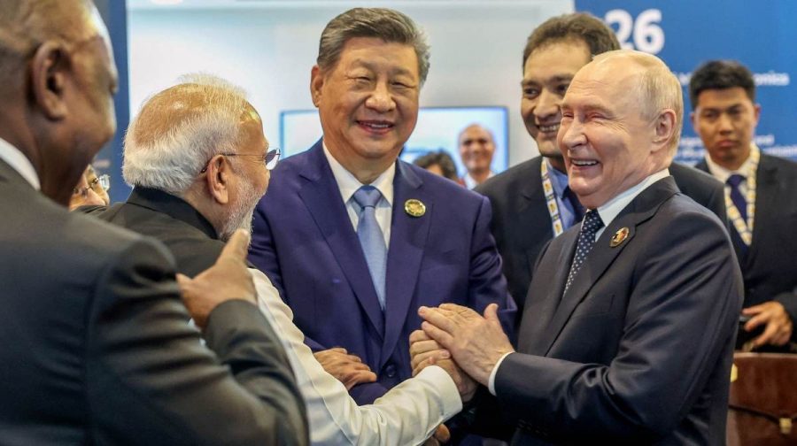 This handout photograph taken on September 12, 2026 and released by India's Ministry of External Affairs (MEA) shows India's Prime Minister Narendra Modi (2L), China's President Xi Jinping (C) and Russia's President Vladimir Putin (R) sharing a light moment during the 18th BRICS Summit in New Delhi. (Photo by Handout / India's Ministry of External Affairs / AFP