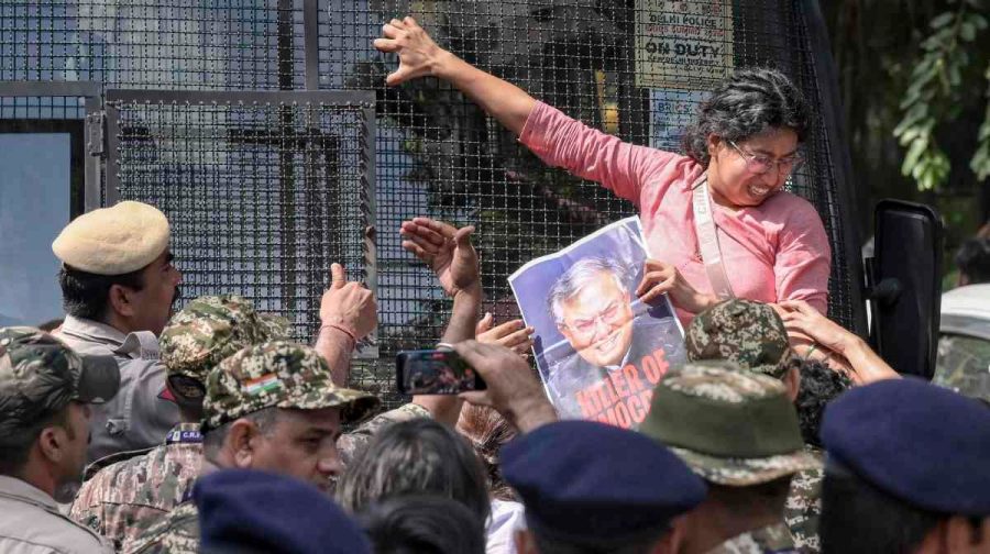 New Delhi: A student activist clings to a Delhi Police bus to stop it from moving away with detained protesters, while security personnel intervene during a demonstration demanding the resignation of Chief Election Commissioner (CEC) Gyanesh Kumar over alleged electoral roll irregularities, near Jantar Mantar, in New Delhi, Friday, Oct. 2, 2026. (PTI Photo)(PTI10_02_2026_000299A)