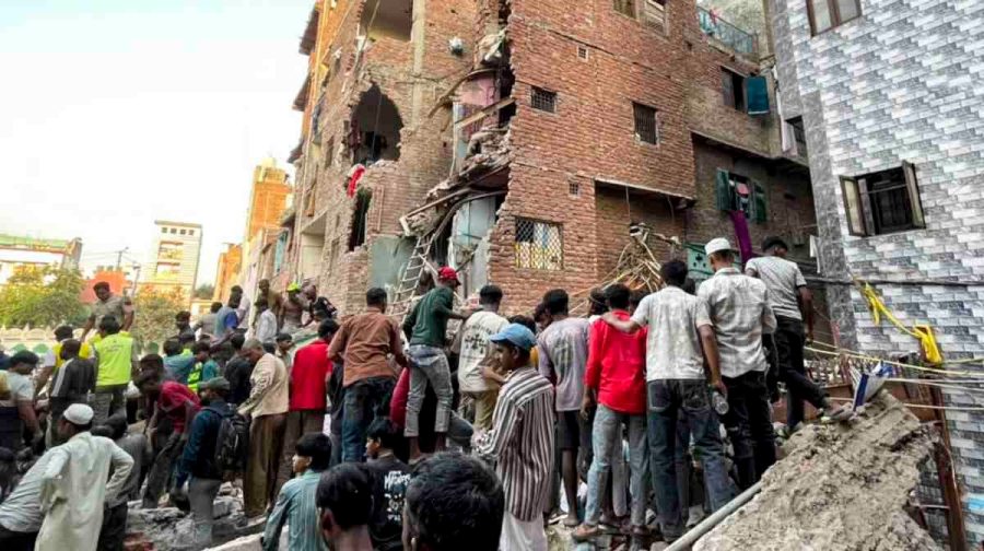 New Delhi: People gather on site after a four-storey building collapsed, with debris burying portions of two to three adjoining houses, in the Seemapuri area, New Delhi, Wednesday, Oct. 7, 2026. At least five people were injured and several others are feared trapped. (PTI Photo/Arjun Sree Kumar)(PTI10_07_2026_000289B)