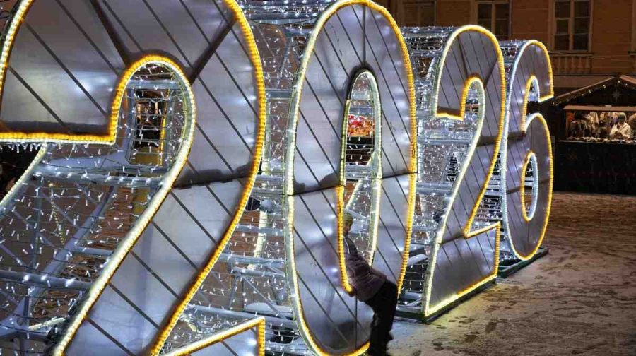 A girl sits in digit 2026 at a Christmas fair opened prior to Christmas and New Year festivities in St. Petersburg, Russia, Tuesday, Dec. 30, 2025. (AP Photo/Dmitri Lovetsky)