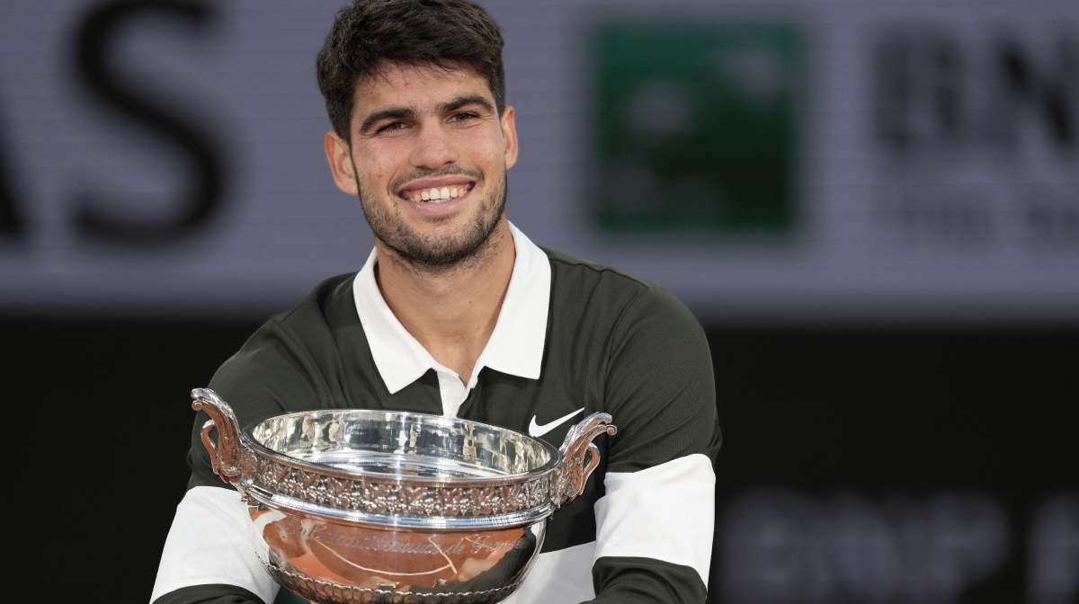 Jun 8, 2025; Paris, FR; Carlos Alcaraz of Spain poses with the trophy after winning the men s singles final against Jannik Sinner of Italy on day 15 at Roland Garros Stadium. Mandatory Credit: Susan Mullane-Imagn Images
