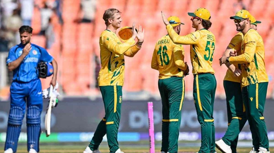 South Africa's captain Aiden Markram (R) celebrates with teammates after their win as Afghanistan's Azmatullah Omarzai (L) reacts at the end of the 2026 ICC Men's T20 Cricket World Cup group stage match between Afghanistan and South Africa in the Narendra Modi Stadium, Ahmedabad on February 11, 2026. (Photo by Shammi MEHRA / AFP)