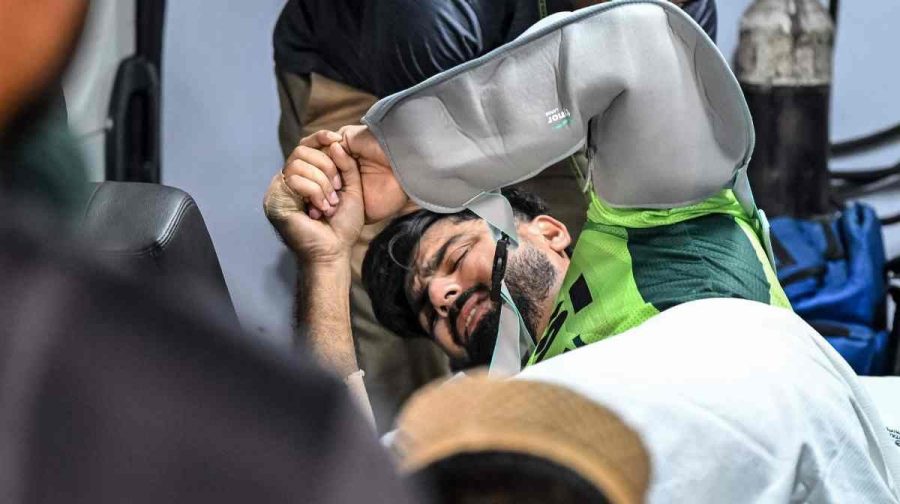 Pakistan's Hussain Talat reacts in pain as he is taken to the hospital using a stretcher after getting injured while fielding during the second one-day international (ODI) cricket match between Bangladesh and Pakistan at Sher-e-Bangla National Stadium in Mirpur on March 13, 2026. (Photo by Munir UZ ZAMAN / AFP)