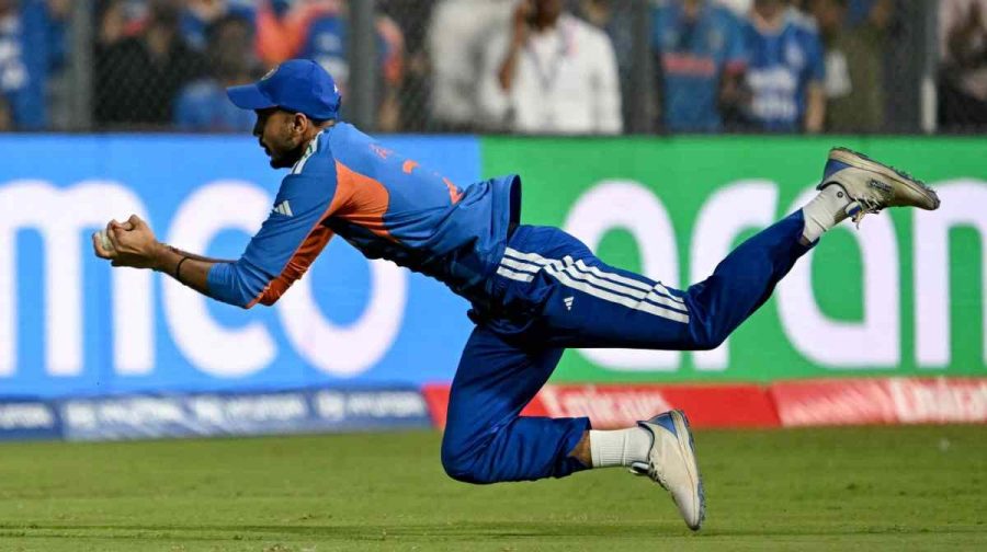 India's Axar Patel takes a catch to dismiss England's captain Harry Brook during the 2026 ICC Men's T20 Cricket World Cup semi-final match between India and England at the Wankhede Stadium in Mumbai on March 5, 2026. (Photo by Indranil MUKHERJEE / AFP)