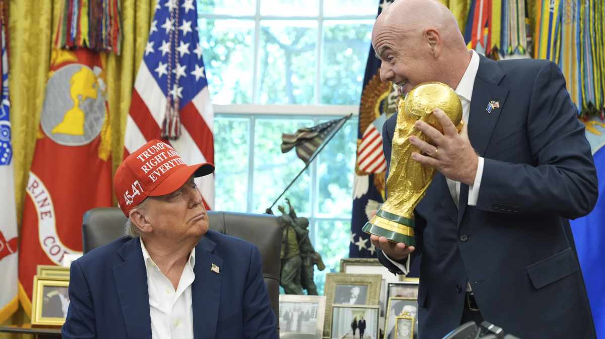 FIFA President Gianni Infantino, right, prepares to hand the FIFA World Cup Winners Trophy to President Donald Trump during an announcement in the Oval Office of the White House, Friday, Aug. 22, 2025, in Washington. AP/PTI(AP08_23_2025_000006B)