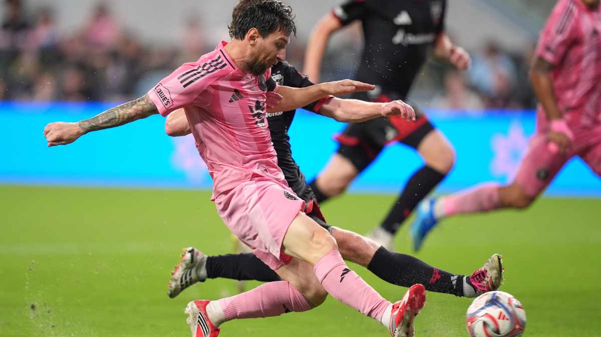 Inter Miami forward Lionel Messi, front, vies with D.C. United defender Kye Rowles, obscured, during the first half of an MLS soccer match, Saturday, Oct. 10, 2026, in Miami. (AP Photo/Rebecca Blackwell)
