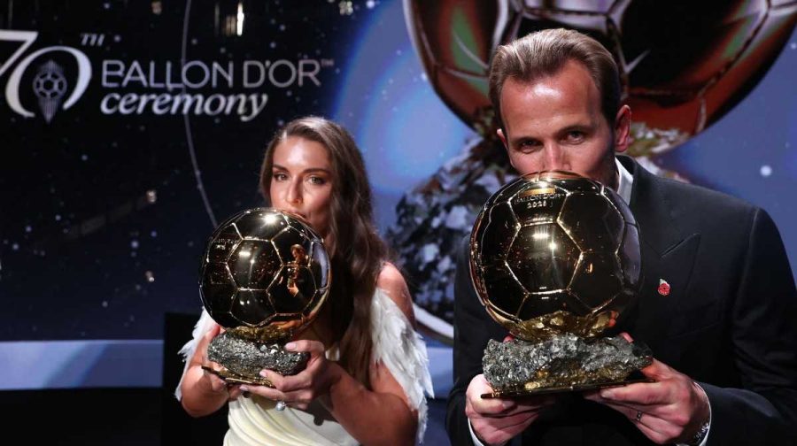 Spain and Barcelona midfielder Alexia Putellas and England and Bayern Munich forward Harry Kane kiss their trophies on stage after receiving their Ballon d'Or awards for the best female and male footballer during the 2026 Ballon d'Or France Football award ceremony at the Palladium Theatre in London on October 26, 2026. (Photo by FRANCK FIFE / AFP)