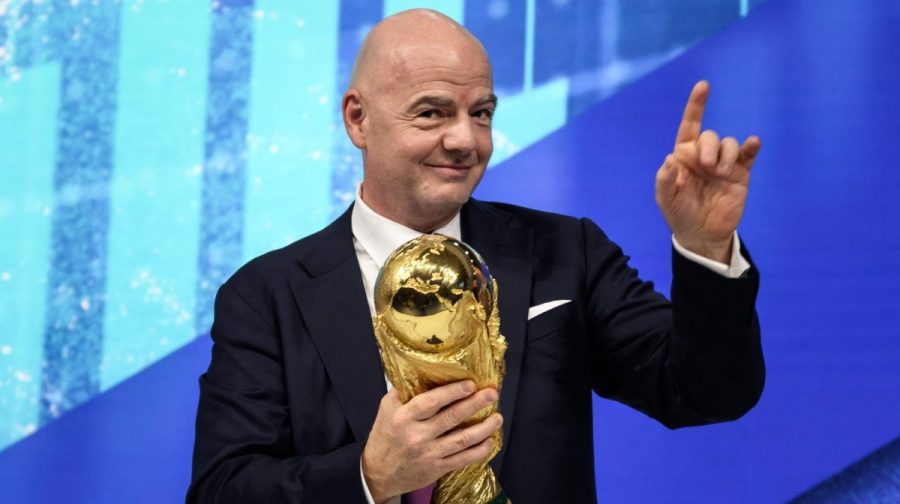 FIFA president Gianni Infantino gestures as he holds the football World Cup trophy during the World Economic Forum (WEF) annual meeting in Davos on May 23, 2022. (Photo by Fabrice COFFRINI / AFP)