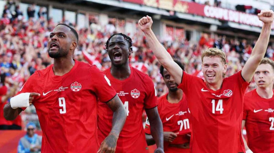 TORONTO, ONTARIO - JUNE 12: Cyle Larin #9 of Canada celebrates with teammates after scoring the team's first goal during the FIFA World Cup 2026 Group B match between Canada and Bosnia and Herzegovina at Toronto Stadium on June 12, 2026 in Toronto, Ontario.   Charlotte Wilson/Getty Images/AFP (Photo by Charlotte Wilson / GETTY IMAGES NORTH AMERICA / Getty Images via AFP)
