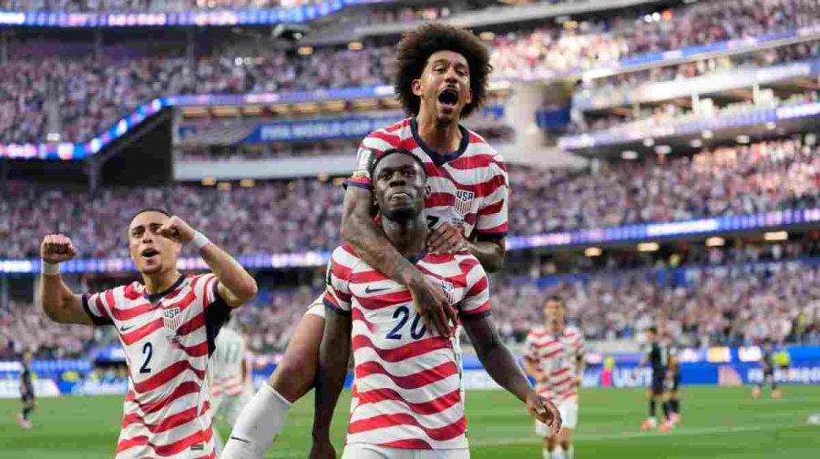 United States' Folarin Balogun (20) celebrates scoring his side's third goal against Paraguay with teamates during the World Cup Group D soccer match in Inglewood, Calif., near Los Angeles, Friday, June 12, 2026. (AP Photo/Andre Penner)