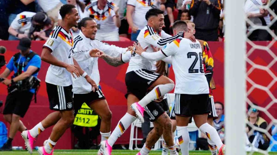 Germany's Deniz Undav (26) is mobbed by teammates after scoring their second goal during the World Cup Group E soccer match between Germany and Ivory Coast in Toronto, Saturday, June 20, 2026. (Frank Gunn/The Canadian Press via AP)