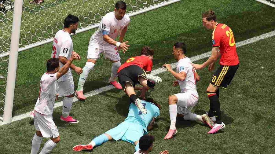 TOPSHOT - Iran's goalkeeper #01 Alireza Beiranvand makes a save past Belgium's defender #05 Maxim De Cuyper during the 2026 World Cup Group G football match between Belgium and Iran at the Los Angeles Stadium in Inglewood on June 21, 2026.  (Photo by Etienne Laurent / AFP)