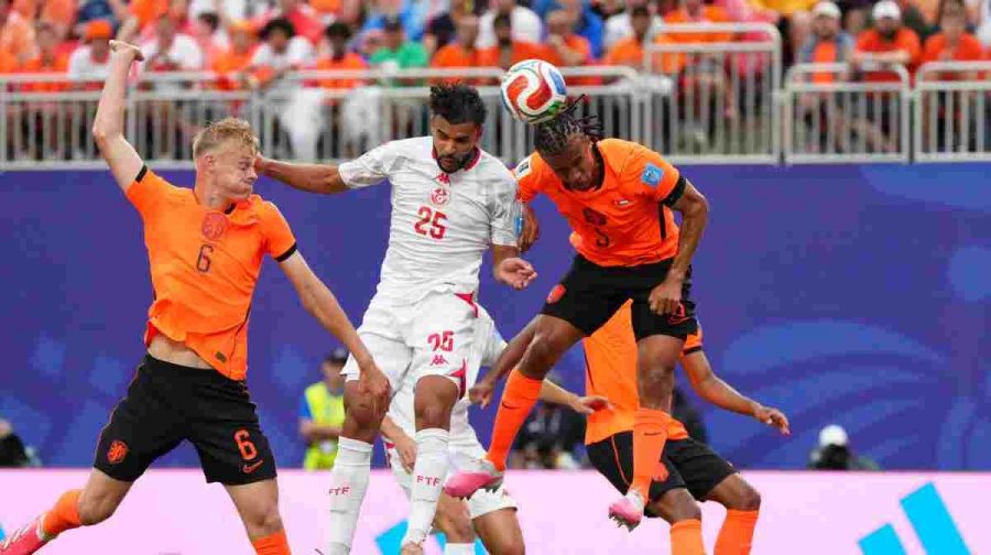 Tunisia's Anis Slimane jumps for the ball with Netherlands' Nathan Ake, right, and Jan Paul van Hecke during the World Cup Group F soccer match between Tunisia and the Netherlands in Kansas City, Mo., Thursday, June 25, 2026. (AP Photo/Ed Zurga)