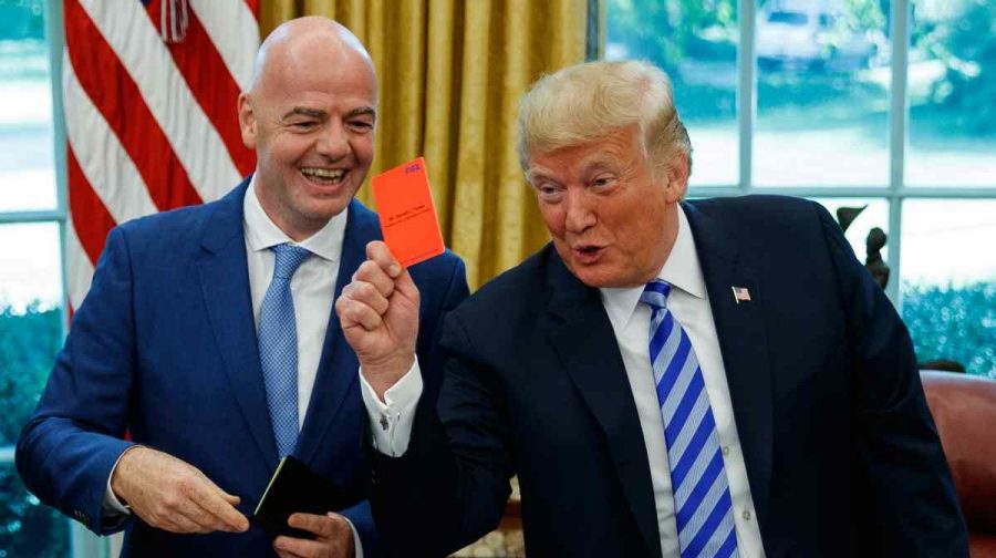 FILE - President Donald Trump holds up a red card during a meeting with FIFA president Gianni Infantino in the Oval Office of the White House, Tuesday, Aug. 28, 2018, in Washington. (AP Photo/Evan Vucci, File)