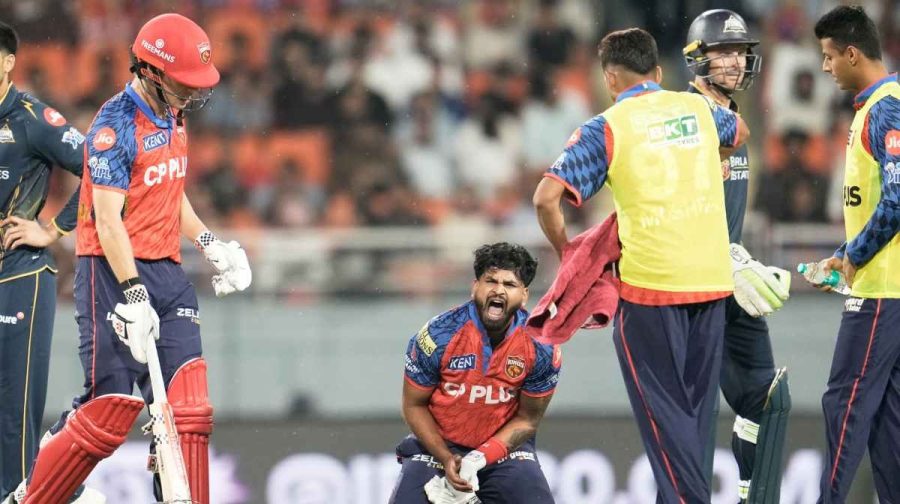 Punjab Kings' captain Shreyas Iyer, center, winces in pain after getting hit by a shot from batting partner Cooper Connolly, second left, during the Indian Premier League cricket match between Gujarat Titans and Punjab Kings in New Chandigarh, India, Tuesday, March 31, 2026. (AP Photo/Ashwini Bhatia)