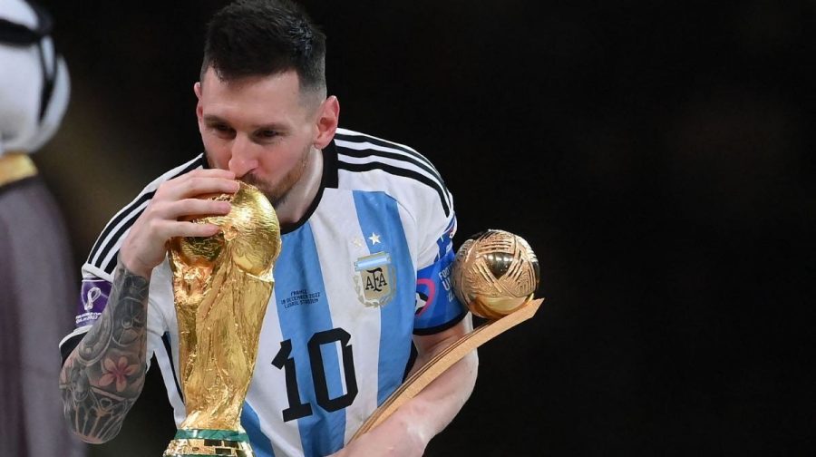 Argentina's forward #10 Lionel Messi kisses the World Cup trophy after receiving the Golden Ball award during the Qatar 2022 World Cup trophy ceremony after the football final match between Argentina and France at Lusail Stadium in Lusail, north of Doha on December 18, 2022. (Photo by FRANCK FIFE / AFP)