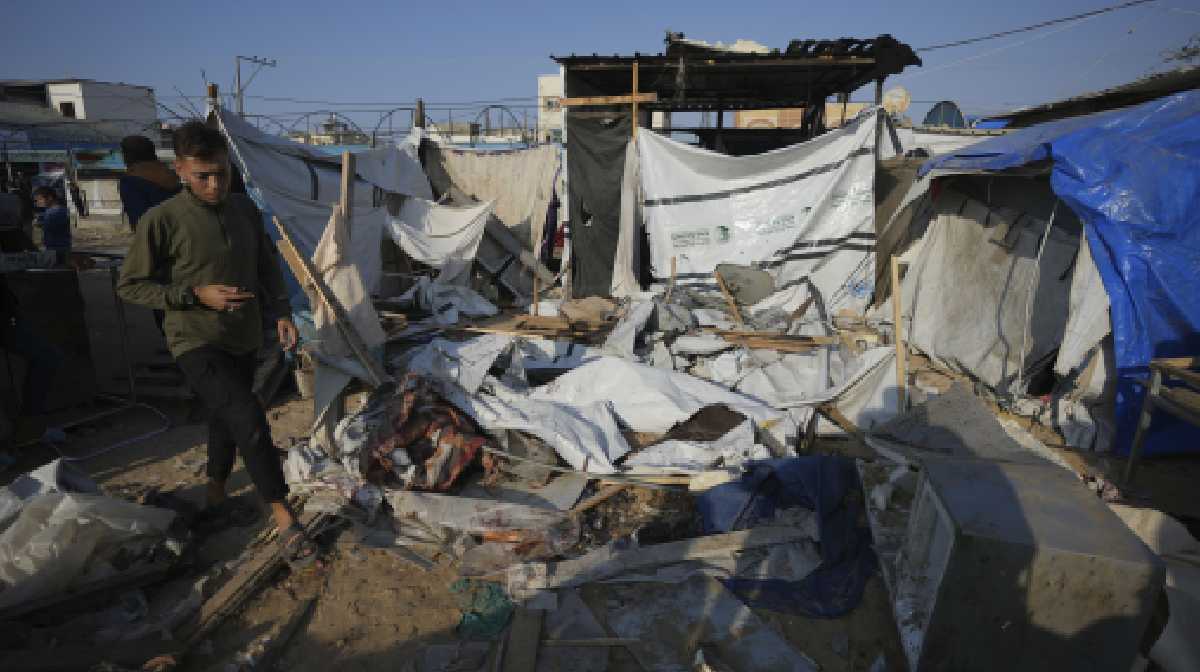A Palestinian walks through the site of an Israeli strike in the courtyard of the Al-Aqsa Hospital in Deir al-Balah, Gaza Strip, Saturday, Nov. 9, 2024. (AP Photo/Abdel Kareem Hana)